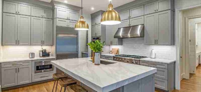 Stylish modern kitchen featuring a large marble island, gold pendant lights, and gray cabinetry., tags: farbe, und - pexel